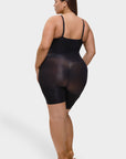 Woman wearing a black bodysuit on a white background
