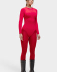 Person wearing a red bodysuit and gray boots on a white background