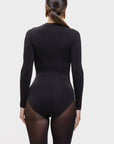 Person wearing a black bodysuit on a white background