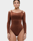 Woman wearing a brown bodysuit on a white background
