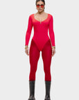Person wearing a red bodysuit with black boots on a white background