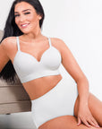 Woman wearing a white swimsuit against a neutral background