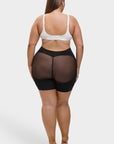 women wearing a white bra and black sheer shorts on a white background