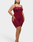 Woman wearing a burgundy swimsuit against a white background