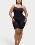Woman wearing a black shapewear bodysuit on a white background