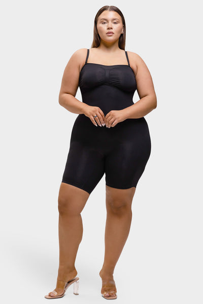 Woman wearing a black bodysuit on a white background