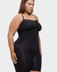 Woman wearing a black shapewear bodysuit on a white background