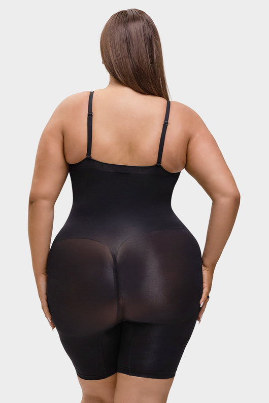 Person wearing a black bodysuit on a white background