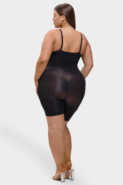 Woman wearing a black bodysuit on a white background