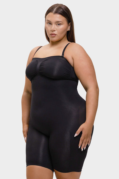 Woman wearing a black shapewear bodysuit on a white background