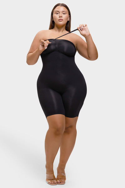 Woman wearing a black bodysuit against a white background