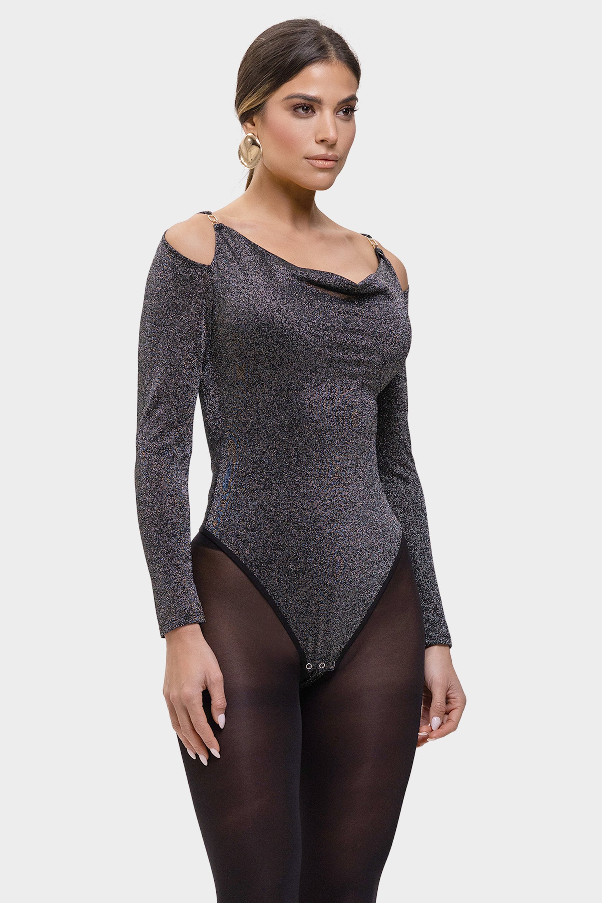 Woman wearing a black patterned bodysuit on a white background