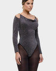 Woman wearing a black patterned bodysuit on a white background