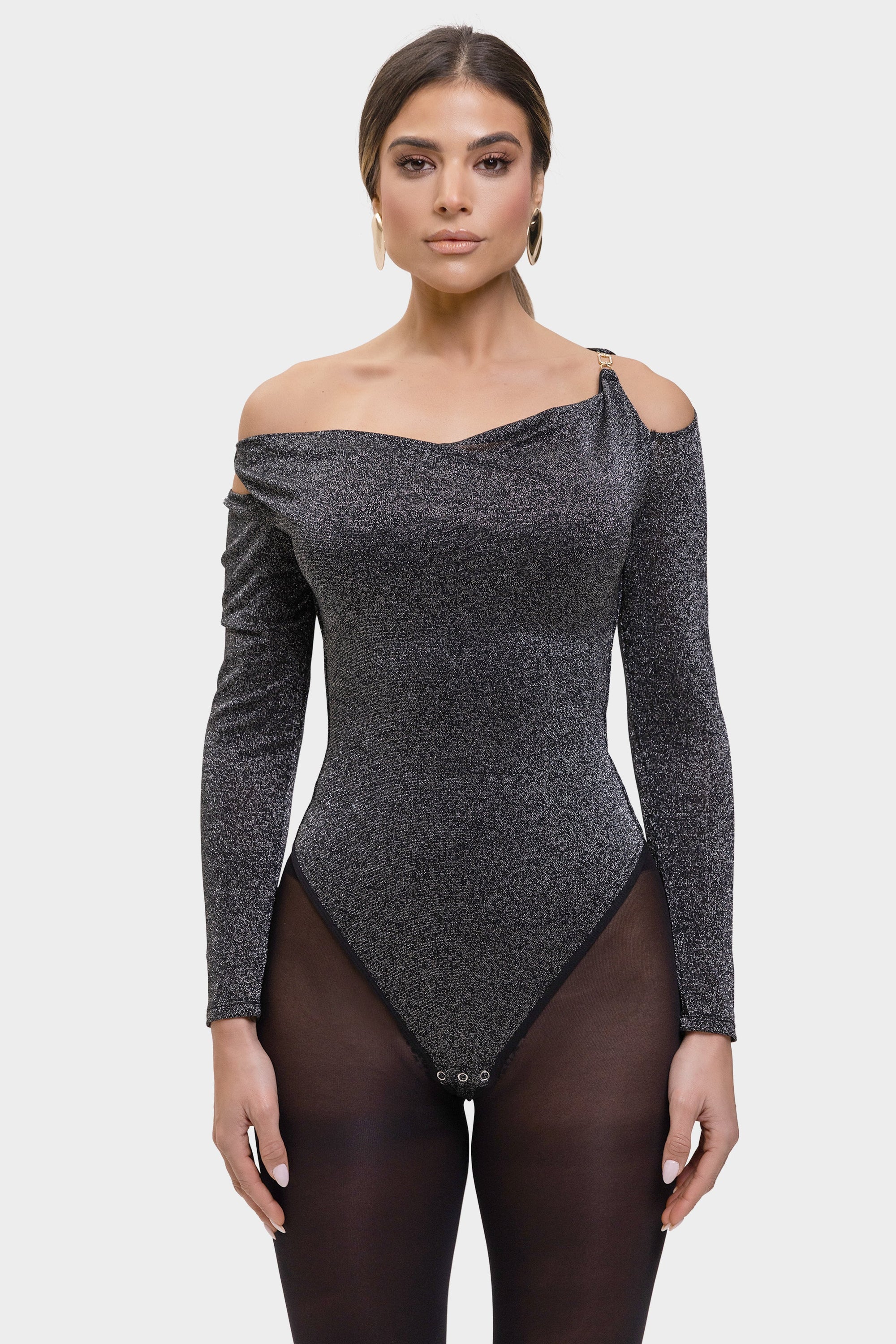 Woman wearing a black off-shoulder bodysuit on a white background