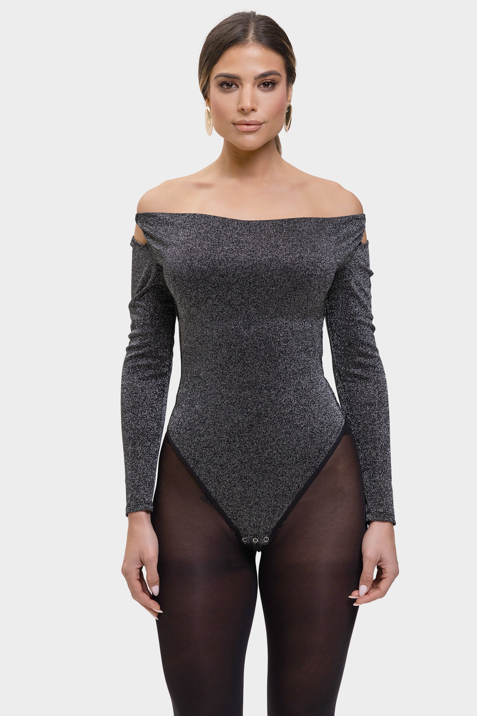 Woman wearing a gray off-shoulder bodysuit on a white background