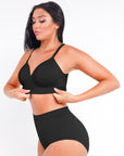 Woman wearing a black bikini set on a white background