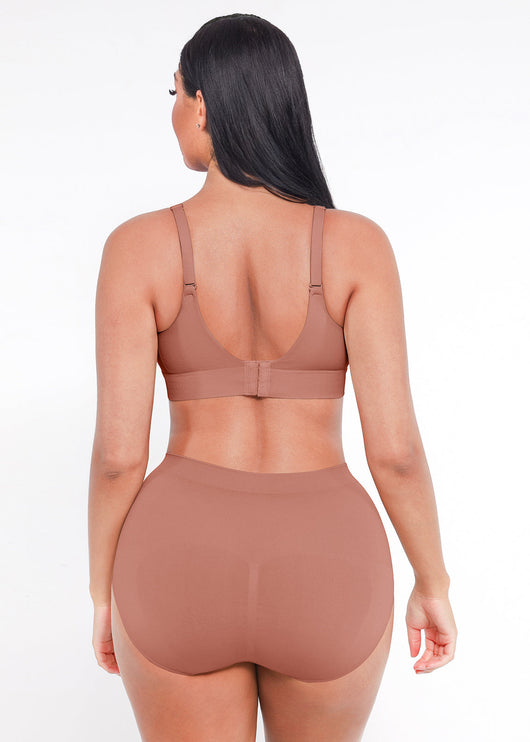 Woman wearing a brown sports bra and high-waisted leggings on a white background