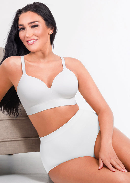 Woman wearing a white swimsuit against a neutral background