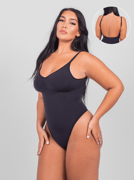 Woman wearing a black swimsuit with a close-up inset on a gray background