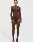 Person wearing a brown bodysuit on a white background