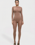 Woman wearing a brown bodysuit on a white background