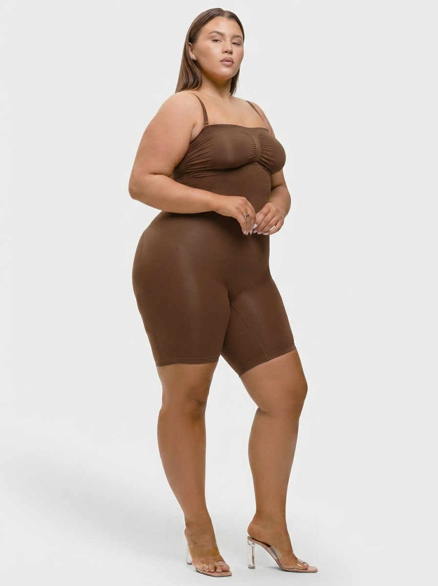 Woman wearing a brown bodysuit on a white background