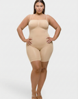 Woman wearing a beige shapewear bodysuit on a white background