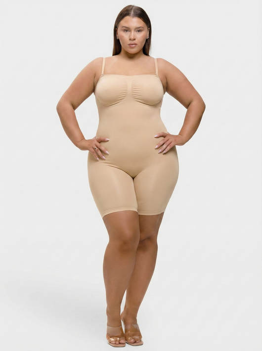 Woman wearing a beige shapewear bodysuit on a white background