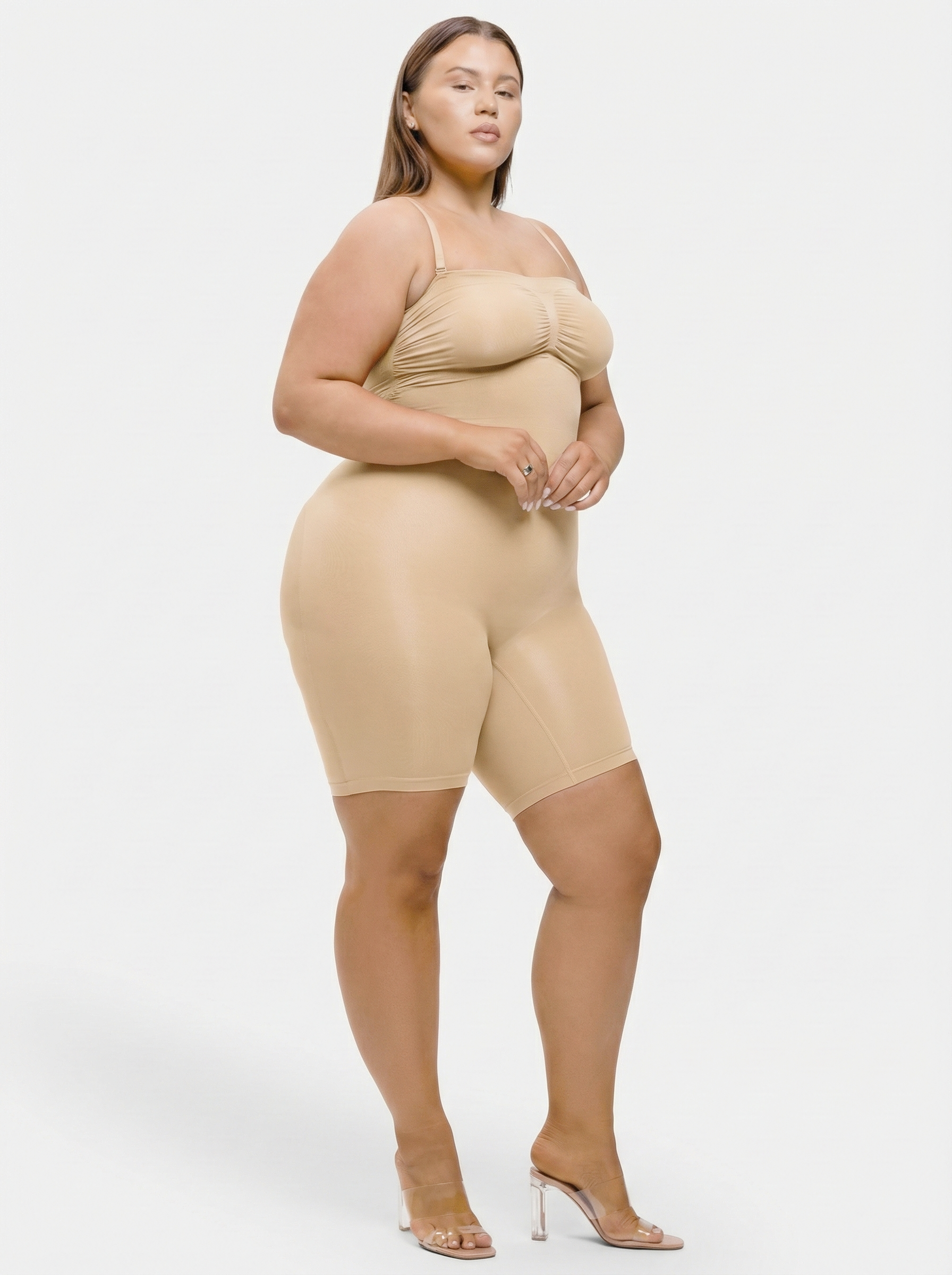 Woman wearing a beige shapewear outfit on a white background