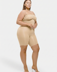 Woman wearing a beige shapewear outfit on a white background